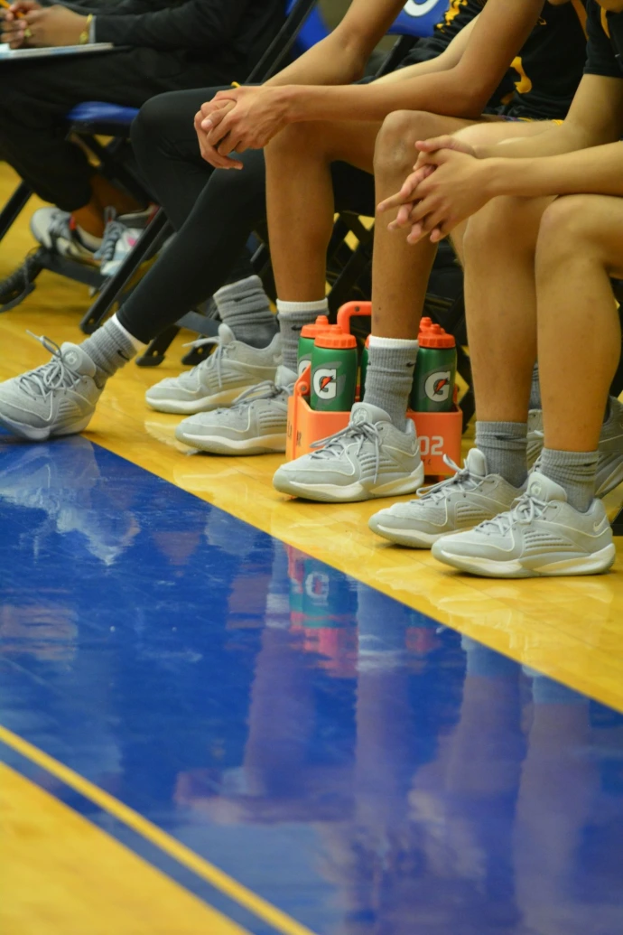 a group of people sitting on top of a basketball court